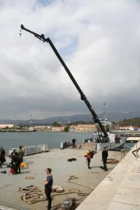 Une grue flottante permet de remonter les déchets rassemblés par les plongeurs