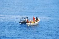 Un mécanicien essaie de réparer le moteur du skiff